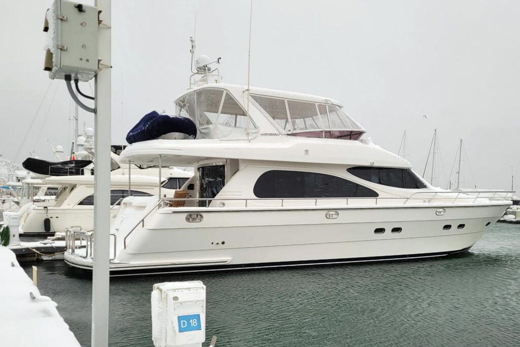 Boat covered in snow during winter illustrating Larsen Marine’s snow removal service